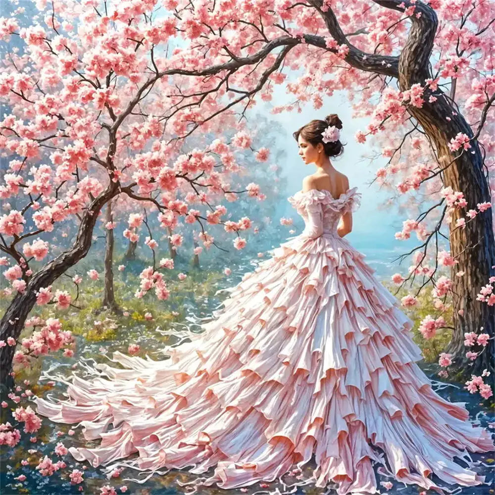 Woman in a pink dress standing under a cherry blossom tree